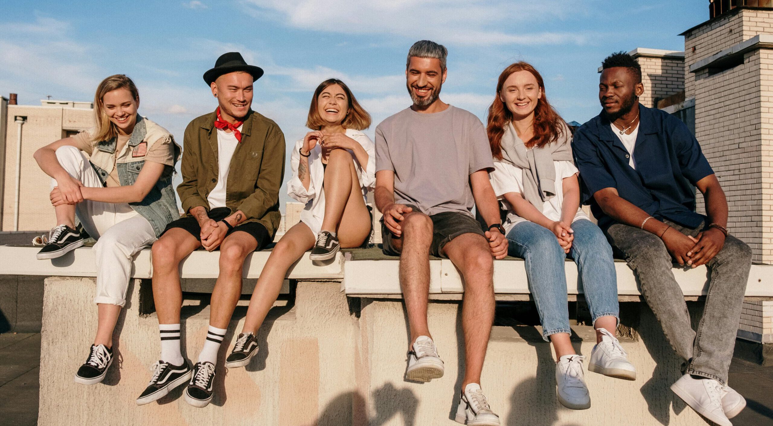 Happy group of Smart Team members sitting on a roof.